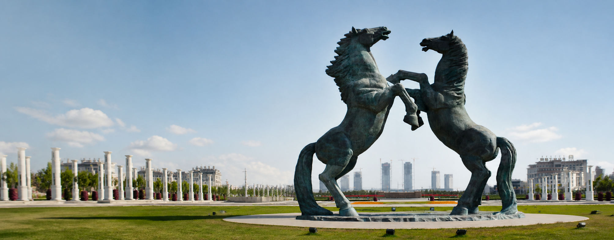 Pair of monumental Trevi bronze rearing horse sculptures in an estate landscape